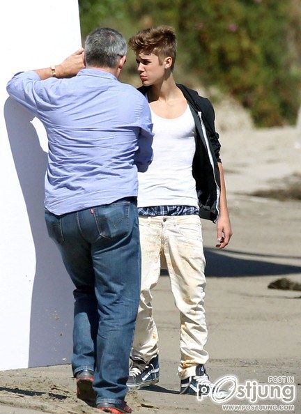 Justin Bieber poses for a photoshoot on the beach in Malibu