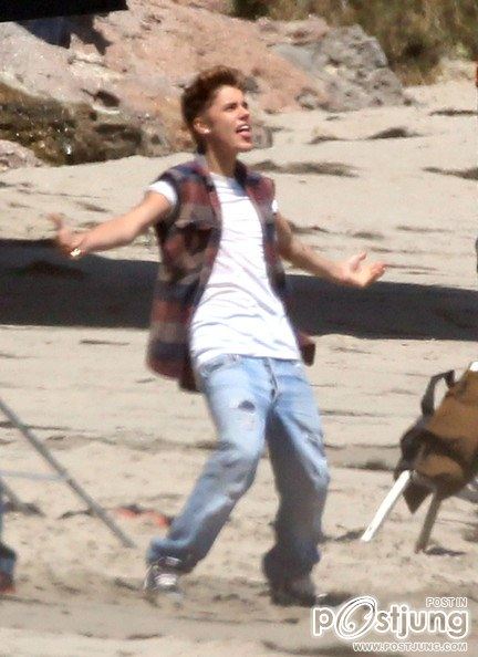 Justin Bieber poses for a photoshoot on the beach in Malibu