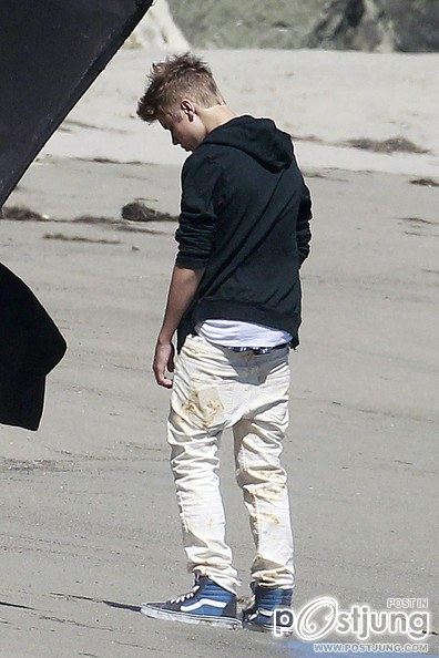 Justin Bieber poses for a photoshoot on the beach in Malibu