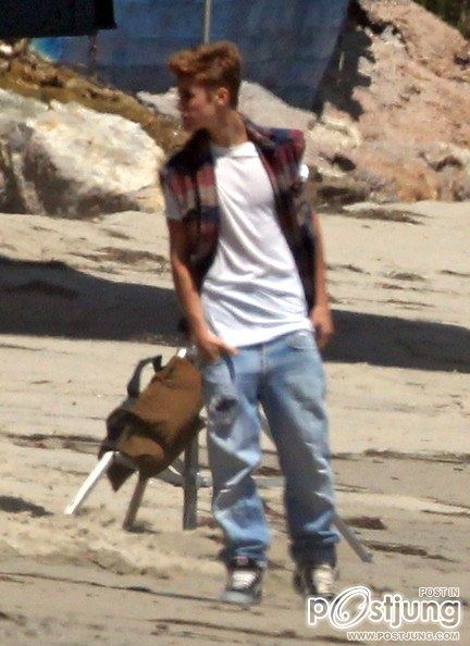 Justin Bieber poses for a photoshoot on the beach in Malibu