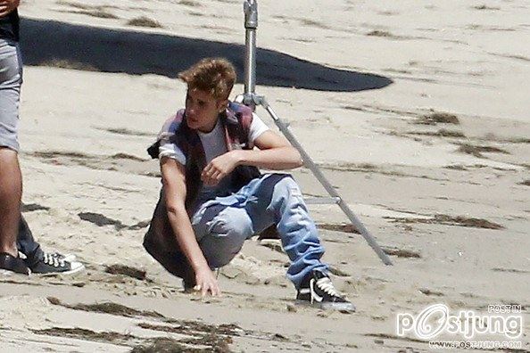 Justin Bieber poses for a photoshoot on the beach in Malibu