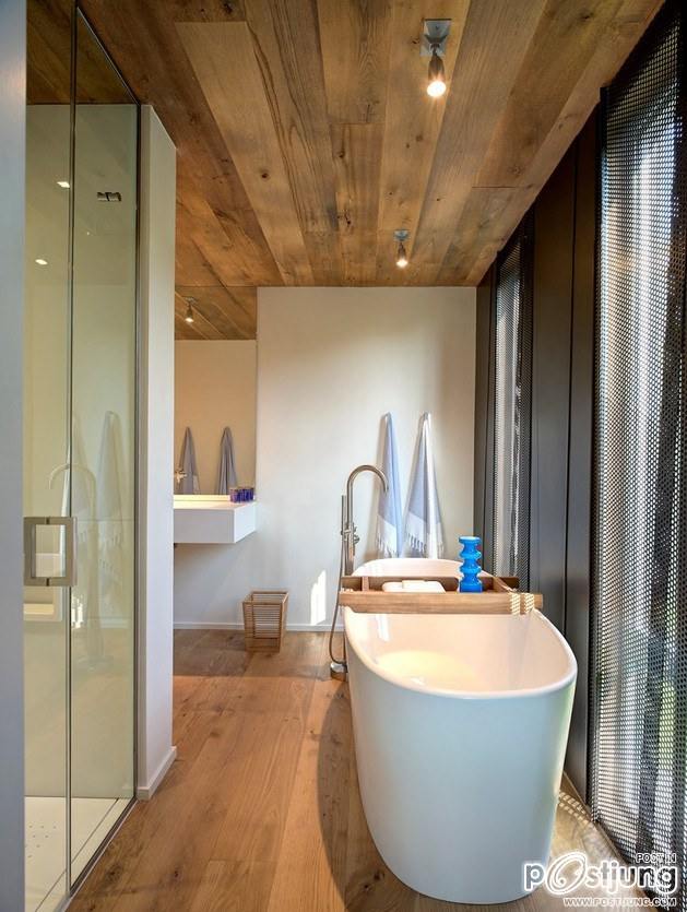 Earthy Timber Clad Interiors vs. Urban Glass Exteriors: Cottage Design by Bates Masi Architects