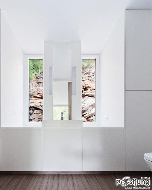 Timber Cabin Built into Cliff Side Site