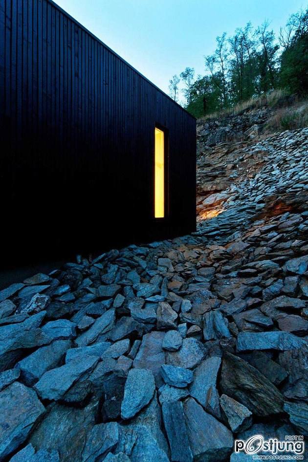 Timber Cabin Built into Cliff Side Site