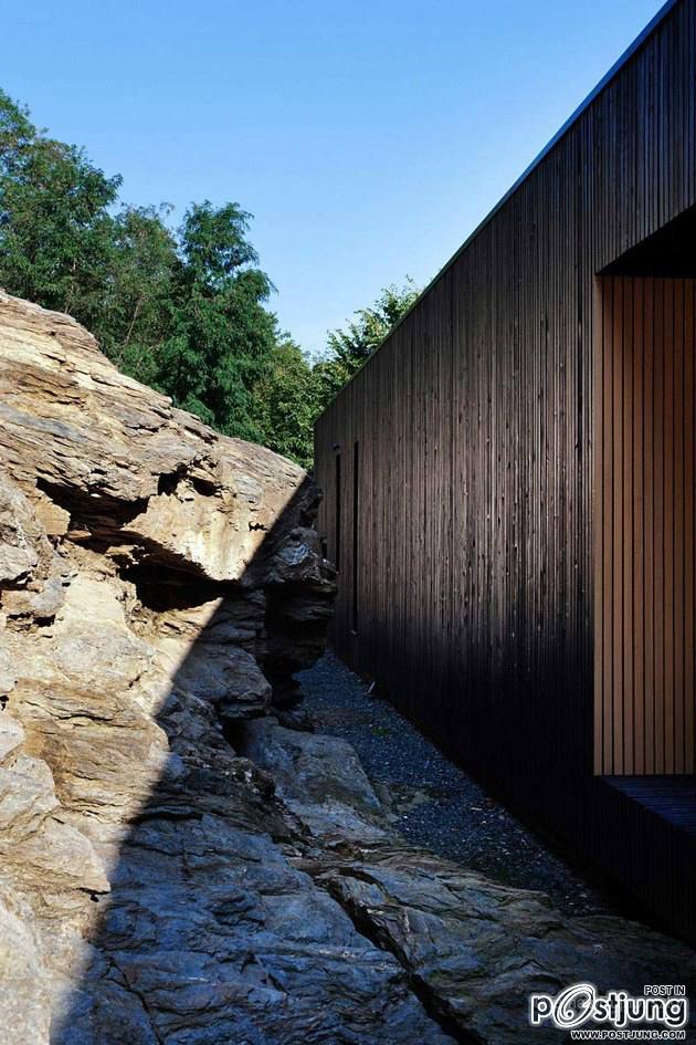 Timber Cabin Built into Cliff Side Site