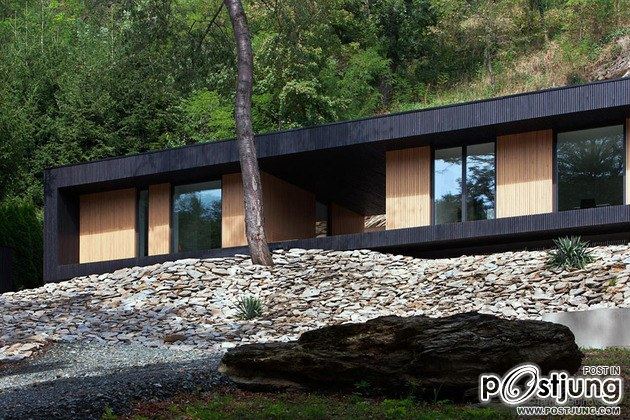 Timber Cabin Built into Cliff Side Site