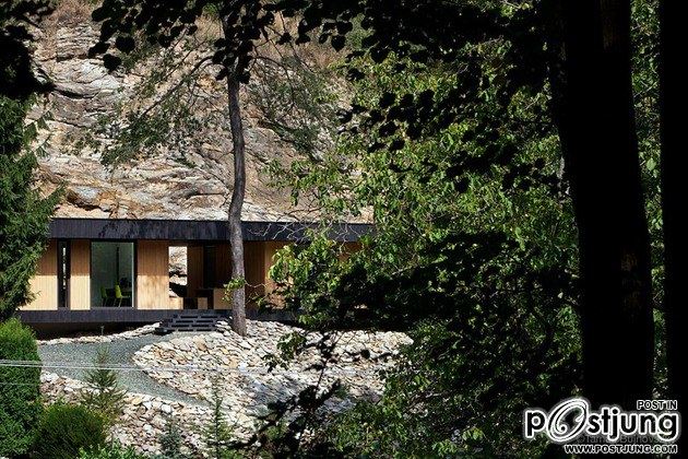 Timber Cabin Built into Cliff Side Site
